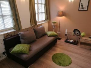 a living room with a couch and two pillows at Apartment Patrícia with garden in Budapest