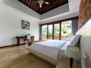 a bedroom with a large bed and a large window at Villa Suzuki 1 Seminyak in Seminyak +34 photos
