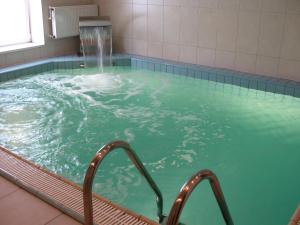 a hot tub with a water fountain at Optima Deluxe Kryvyi Rih in Kryvyi Rih