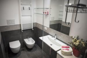 a bathroom with a sink and a toilet and a mirror at Suite GG in Vatican in Rome +11 photos