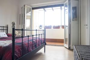 a bedroom with a bed and a sliding glass door at Suite GG in Vatican in Rome