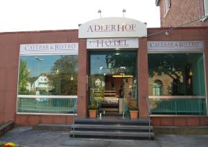 a store front of a hotel with stairs in front at Hotel Adlerhof in Tauberbischofsheim
