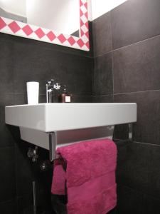 a bathroom with a sink and a pink towel at Trastevere Colors in Rome