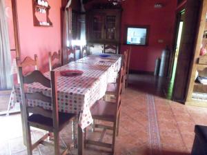 einen Esstisch und Stühle mit einer roten Wand in der Unterkunft La Canaleja in Cigüenza