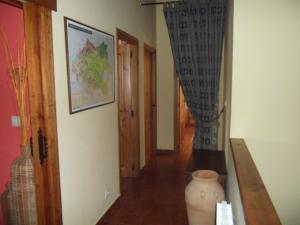 a hallway with a vase sitting on a table in a room at La Canaleja in Cigüenza +16 photos