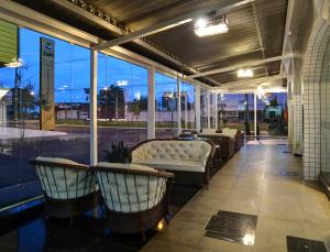 a porch with chairs and a couch in a building at Porto Minas Hotel e Convenções in Uberlândia