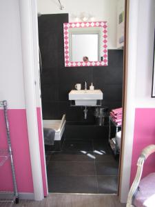 a black and white bathroom with a sink and a mirror at Trastevere Colors in Rome