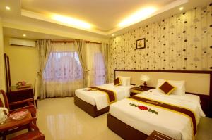 Postel nebo postele na pokoji v ubytování Luxury Nha Trang Hotel + 17 fotografií