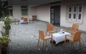 a group of chairs and a table in a courtyard at Hotel Midtown in Haridwār