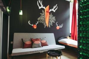 a room with a bed with antlers on the wall at Boutique Apartments Possonium in Bratislava