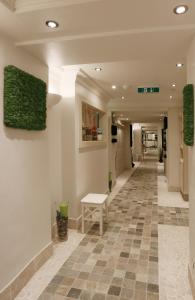 a hallway in a building with a tile floor at Konsumhotel Oberhof - Berghotel Oberhof in Oberhof