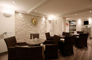 a restaurant with tables and chairs and a wall at Konsum Berghotel Oberhof in Oberhof