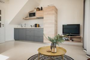 a living room with a table and a tv at Apartmán Dunajky in Dolní Dunajovice