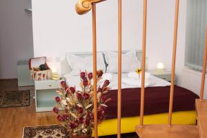 a bedroom with a four poster bed with flowers on the floor at Clermont Sinaia in Sinaia