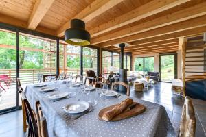 a dining room with a long table in a house at Chalet ToutBlanc in Servoz