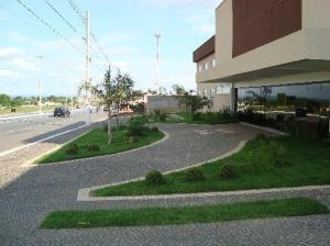 a building with a curvy road next to a building at Senador Plaza Hotel in Senador Canedo