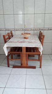 a table with two chairs and a bowl on it at Pousada Mar Verde in Florianópolis +44 photos