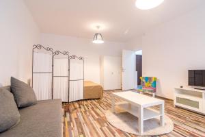 a living room with a couch and a table at Urban Retreat Near Metro & Mega Mall in Bucharest