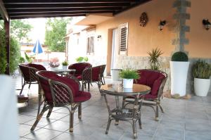 a patio with tables and chairs on a patio at Sunrise in Lascari