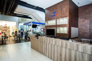 a food counter in a store with people walking around at Travel Inn Bras in São Paulo