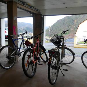 three bikes parked in a building with a view of a mountain at Cochem Ferienwohnung Scheuer in Cochem