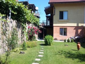 a yard with a house and a stone path at Avel Guest House in Sofia