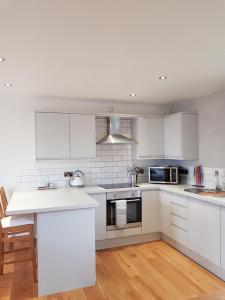 a kitchen with white cabinets and a white counter top at The Studio in Ingoldmells