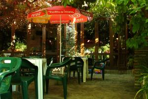 a table and chairs under an umbrella in a garden at Casa Labata in Adahuesca