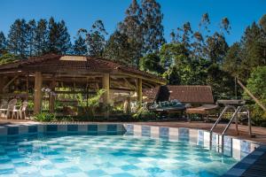 a swimming pool in front of a gazebo at Hotel Vale das Hortênsias in Joinville