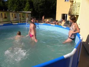 a group of children playing in a swimming pool at Okulski Grand Rozewie in Jastrzębia Góra