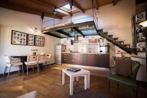 a kitchen and dining room with a table and a staircase at Maison Di Gugli in Brandizzo