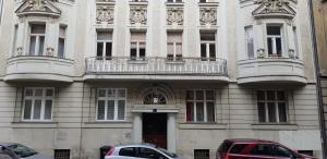 a building with cars parked in front of it at Apartment and Rooms Marinac in Zagreb