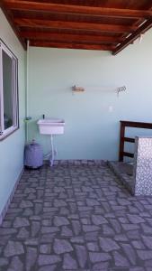 a white room with a sink and a window at Pousada Mar Verde in Florianópolis