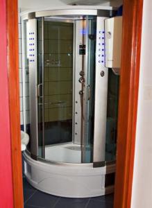 a bathroom with a shower with a glass door at Apartmani Slavica in Jezera