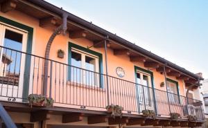 a balcony of a house with a clock on it at Maison Di Gugli in Brandizzo