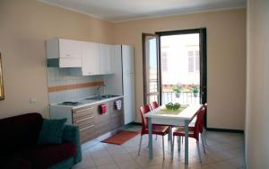 a kitchen with a table and chairs and a kitchen with a window at 4Canti Case Vacanze in Castellammare del Golfo +45 photos