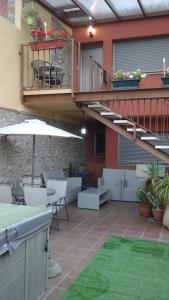 a patio with a staircase and a table and chairs at Mircla in Rocafort de Queralt