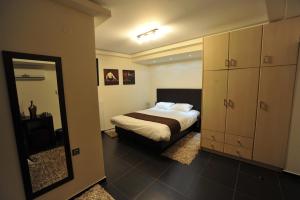 a bedroom with a bed and a mirror at Casa Di Lusso in Ioannina