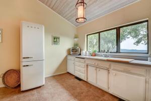 a kitchen with a white refrigerator and a window at Napa Valley Guest House Cottage in Napa