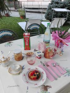 a table with a plate of food on it at B & B Ametista Bergamo in Ponteranica +44 photos