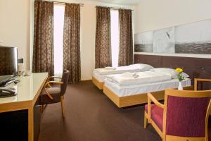 Posteľ alebo postele v izbe v ubytovaní Hotel Purkmistr