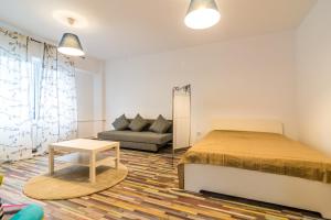 a bedroom with a bed and a couch at Urban Retreat Near Metro & Mega Mall in Bucharest +7 photos