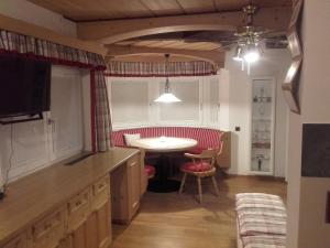 a kitchen with a table and a dining room at Chalet Rustikal in Virgen