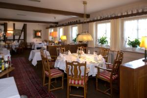 a dining room with a white table and chairs at Jägerhof in Hannover