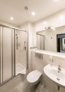 a bathroom with a shower and a toilet and a sink at Jägerhof in Hannover