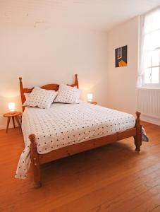 a bedroom with a wooden bed with a wooden floor at Cottage at 7 in Sainte-Foy-la-Grande