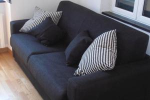 a blue couch with pillows on it in a room at Happy Haven al mare by Portofino in Santa Margherita Ligure