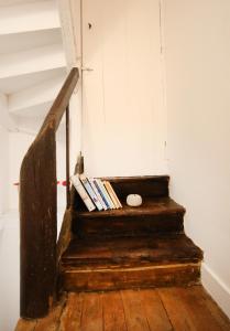 an old wooden stair case with books on it at Cottage at 7 in Sainte-Foy-la-Grande