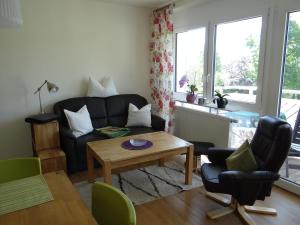 a living room with a couch and a table at Villa Sonnenhof in Bad Steben +3 photos