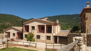 a large house with a mountain in the background at Casas Rurales La Loma in Riópar